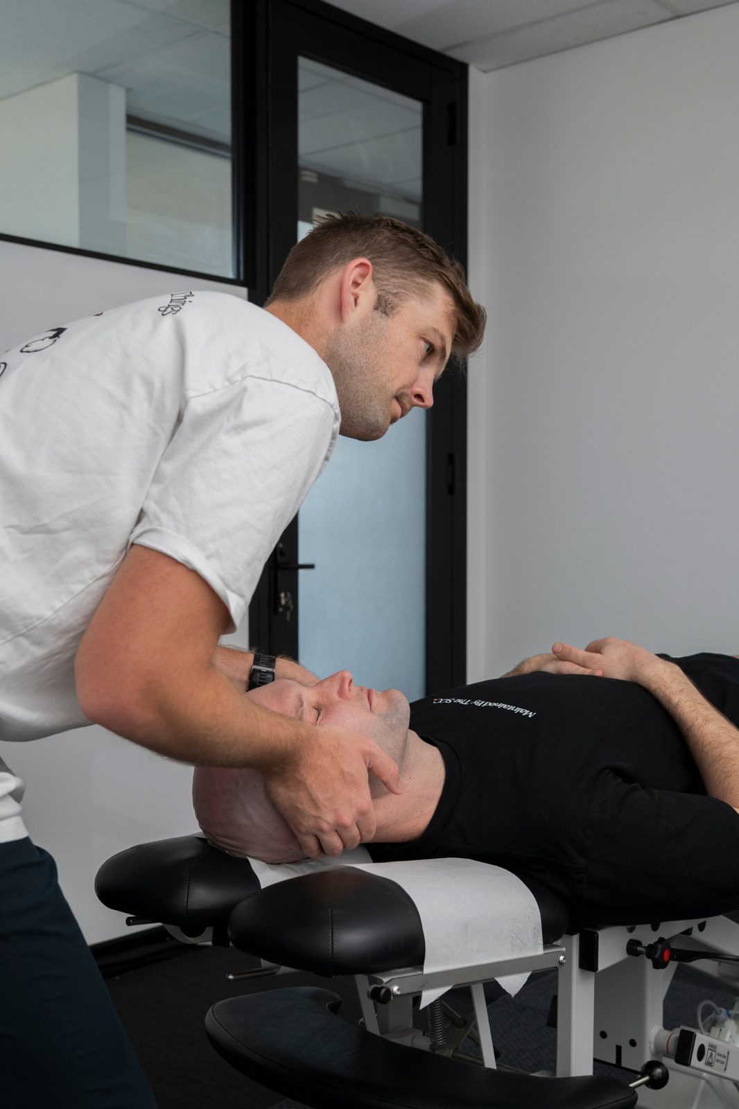 Tim treating a patient's neck on the table
