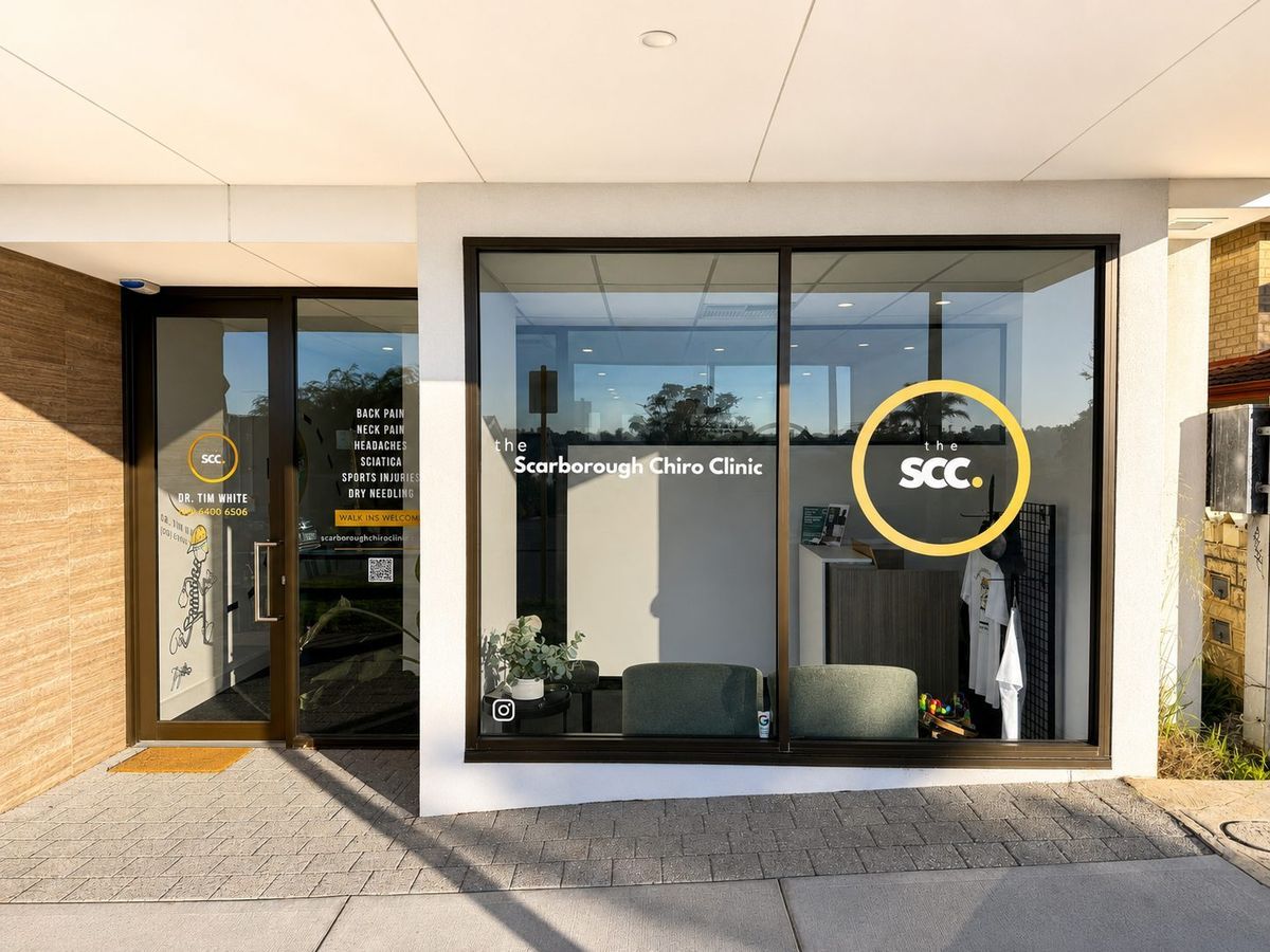 The front entrance of Scarborough Chiro Clinic on Edgehill Street, with the gold SCC circle signage, next to Lady Latte cafe