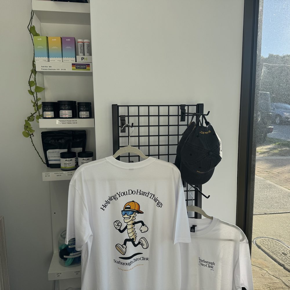 Merch corner with clinic tees, caps, supplements and hydration products