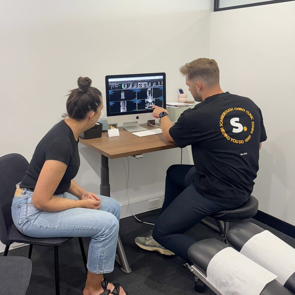 Tim White talking a patient through their MRI scans on screen