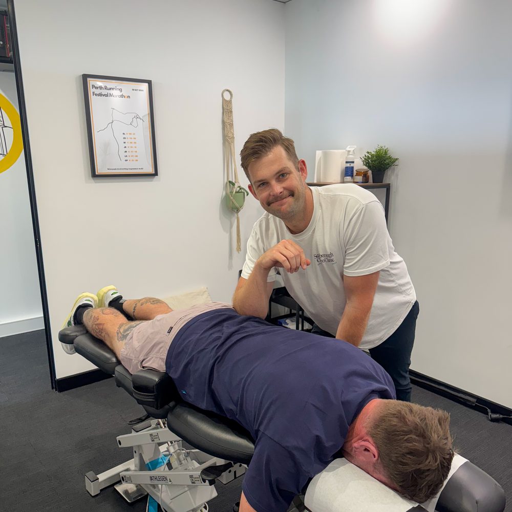 Tim White adjusting a patient on the treatment table