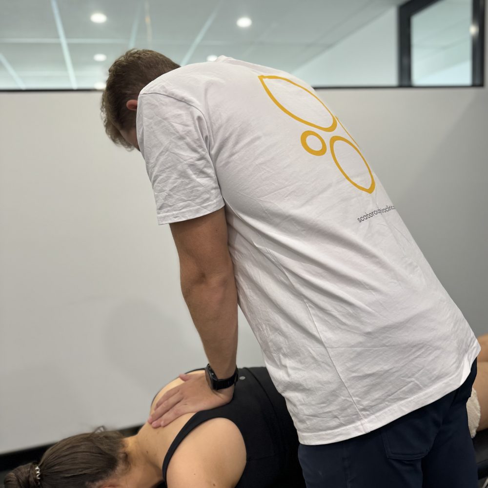 Tim White treating a patient's upper back